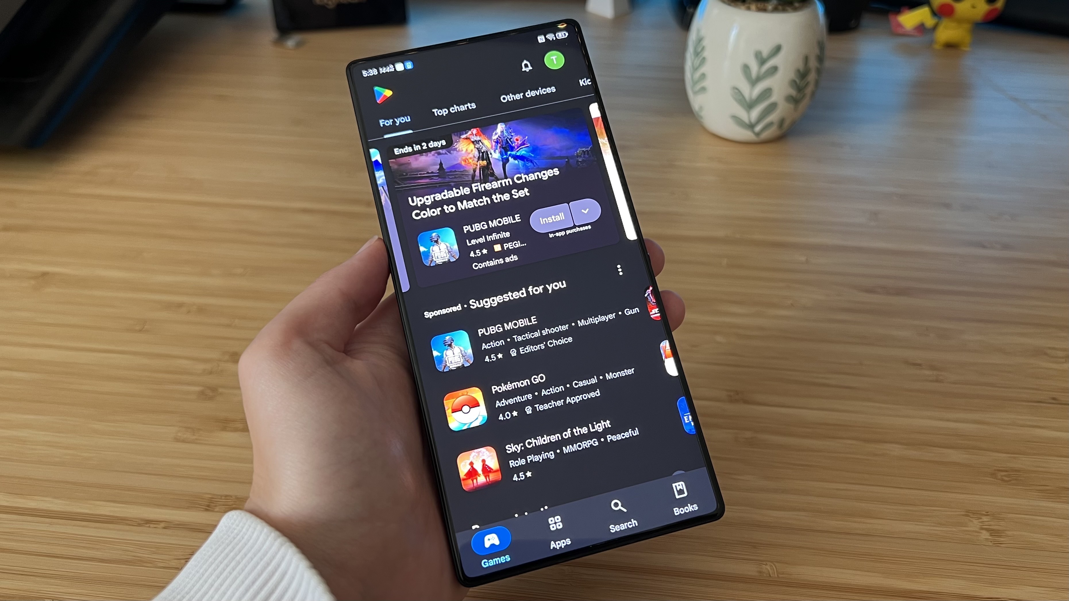 RedMagic 10S Pro on Google Play Store screen being held in reviewer's hand