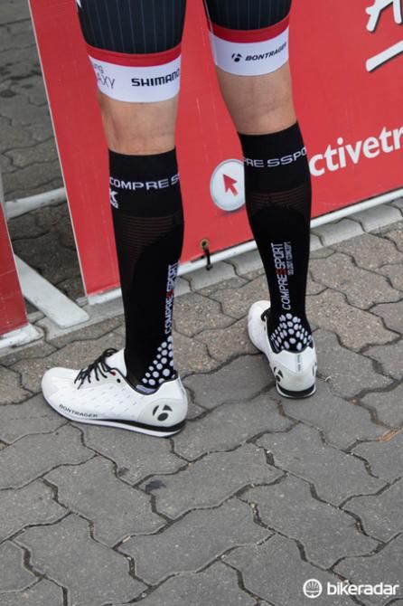 A Trek Factory Racing rider wears Bontrager podium shoes and compression socks before the race start