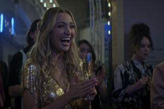 Tilly Keeper as Lady Phoebe holding a glass of wine
