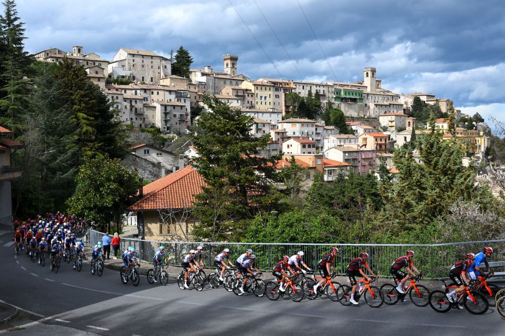 FRONTIGNANO ITALY MARCH 15 Filippo Ganna of Italy and Team INEOS Grenadiers Blue Leader Jerseyand a general view of the peloton passing through Arcevia village during the 60th TirrenoAdriatico 2025 Stage 6 a 163km stage from Cartoceto to Frontignano 1324m UCIWT on March 15 2025 in Frontignano Italy Photo by Tim de WaeleGetty Images