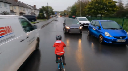 Young child riding bike in close pass