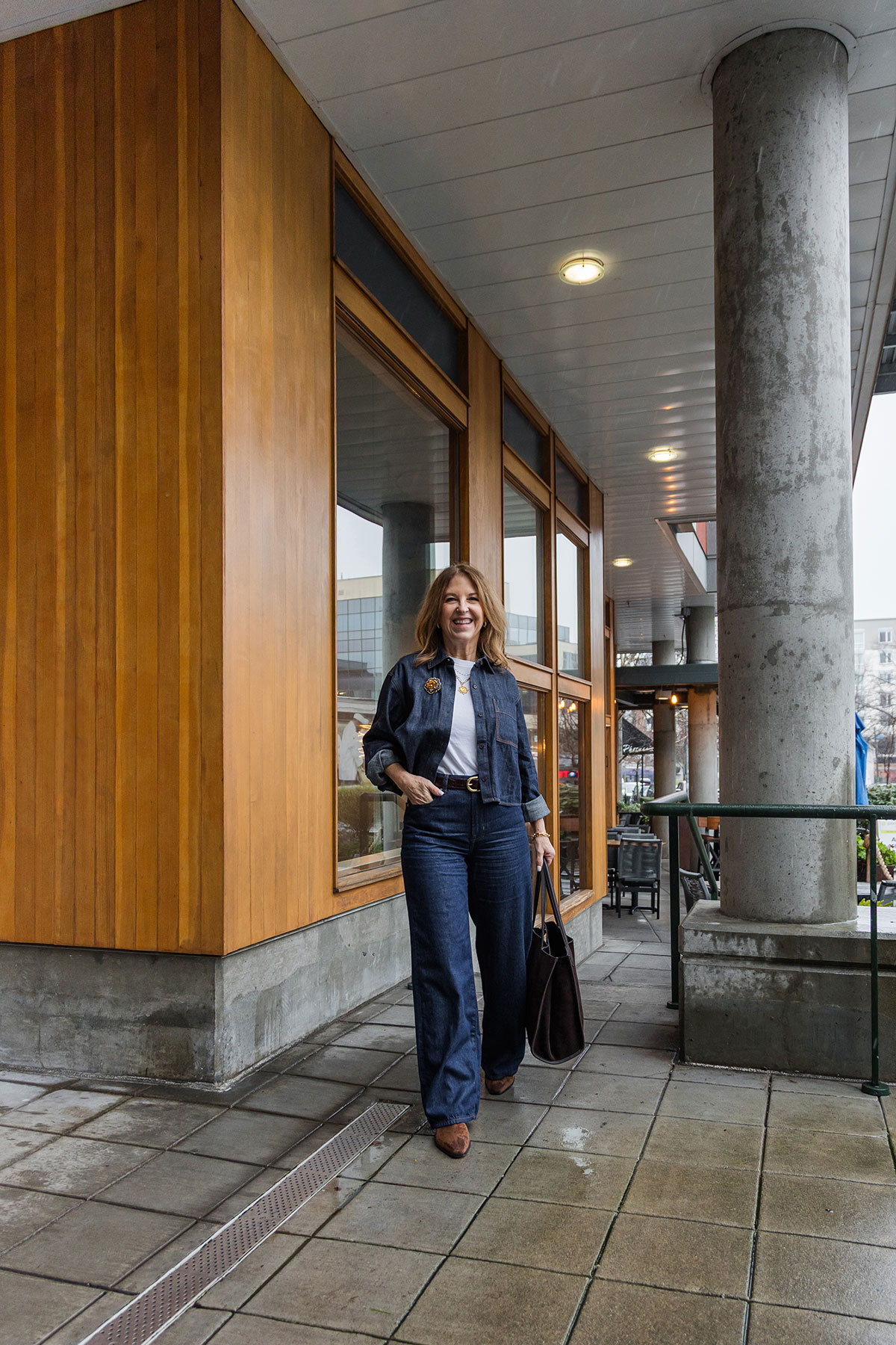 A former Nordstrom stylist wearing a cropped denim shirt over a white tee and matching jeans.