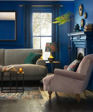 Dark blue living room with multiple mirrors including three round mirrors and one square fixture