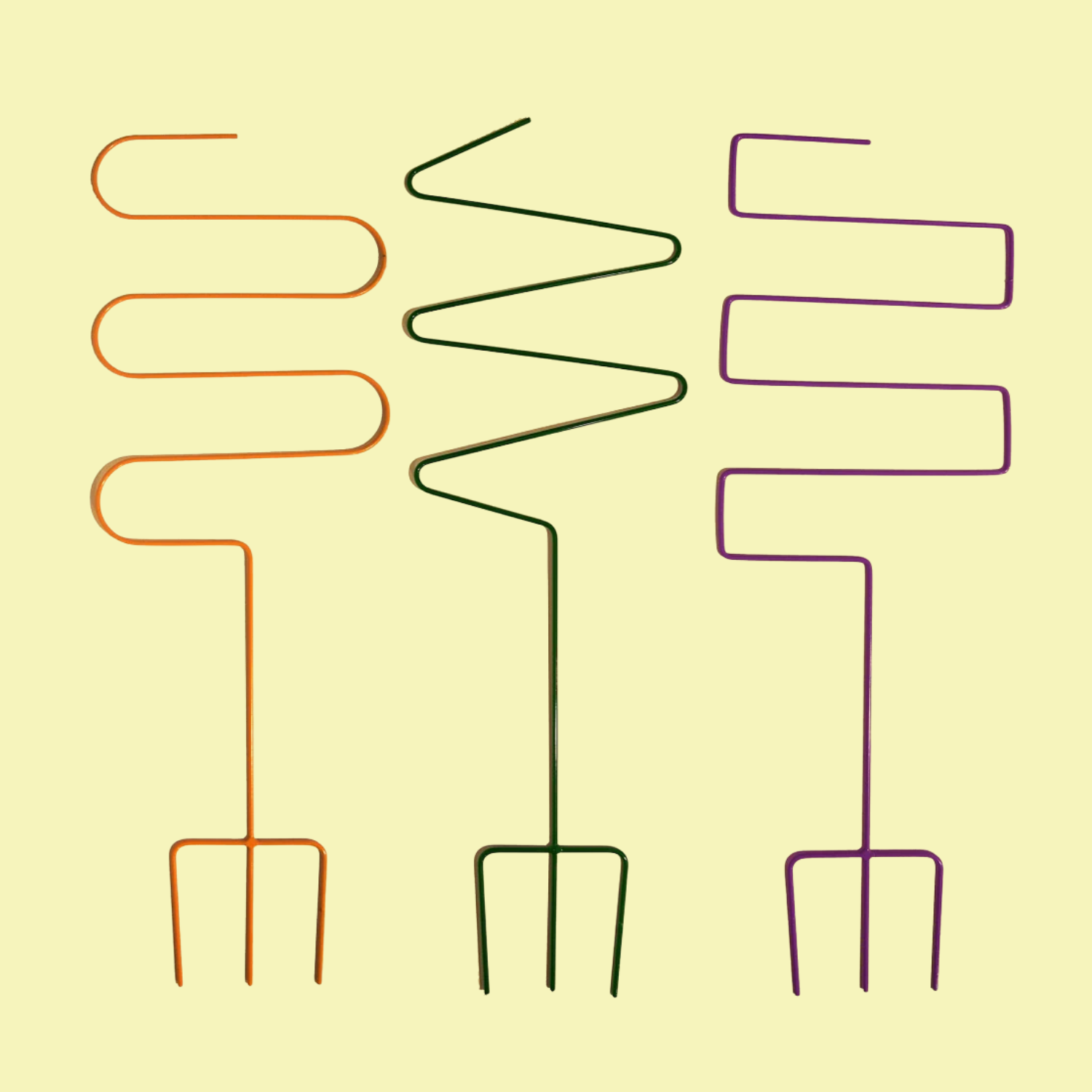 A set of three colored curved plant support stakes