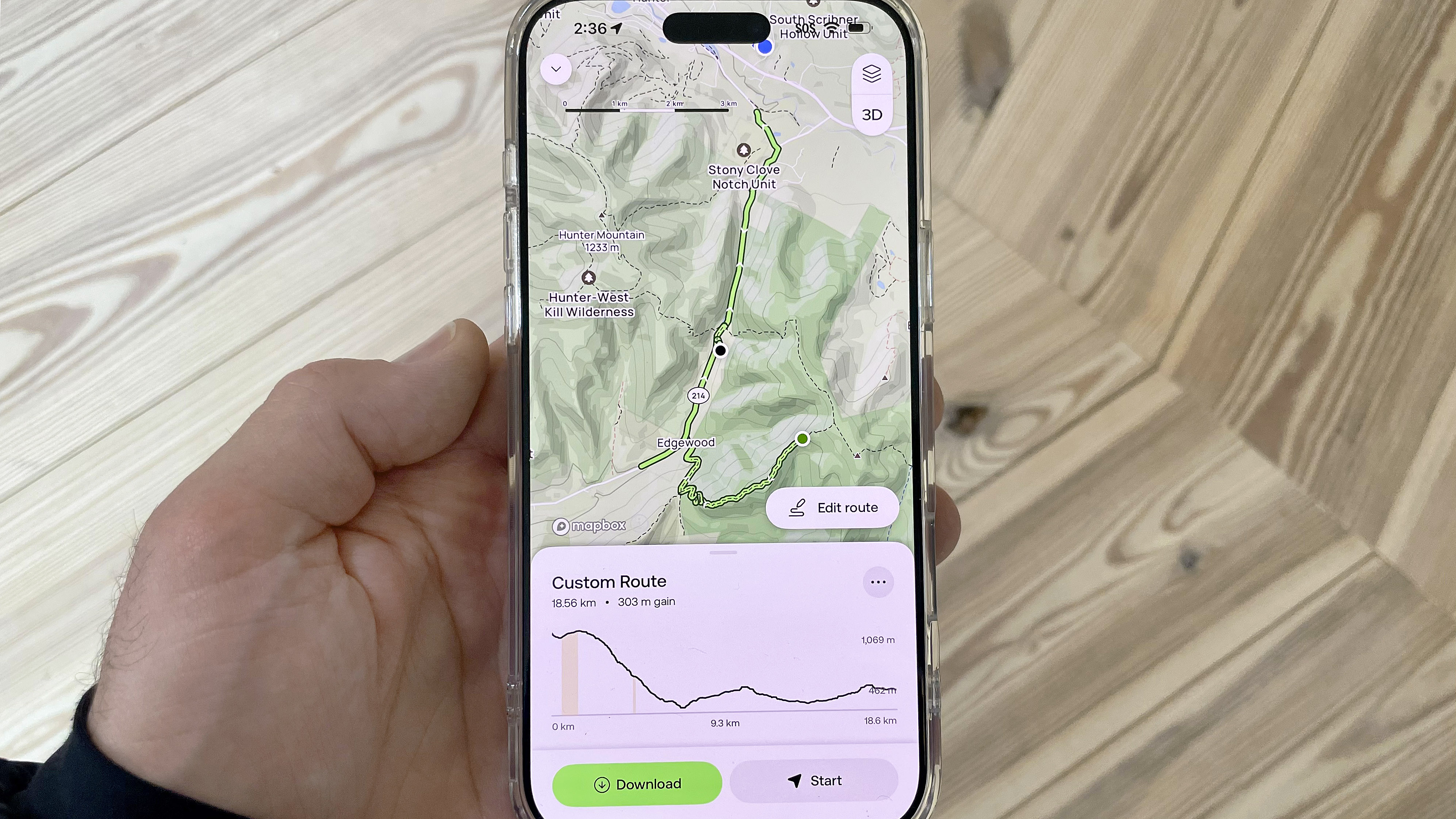 Close-up of an AllTrails user's phone showing the new custom trail building feature