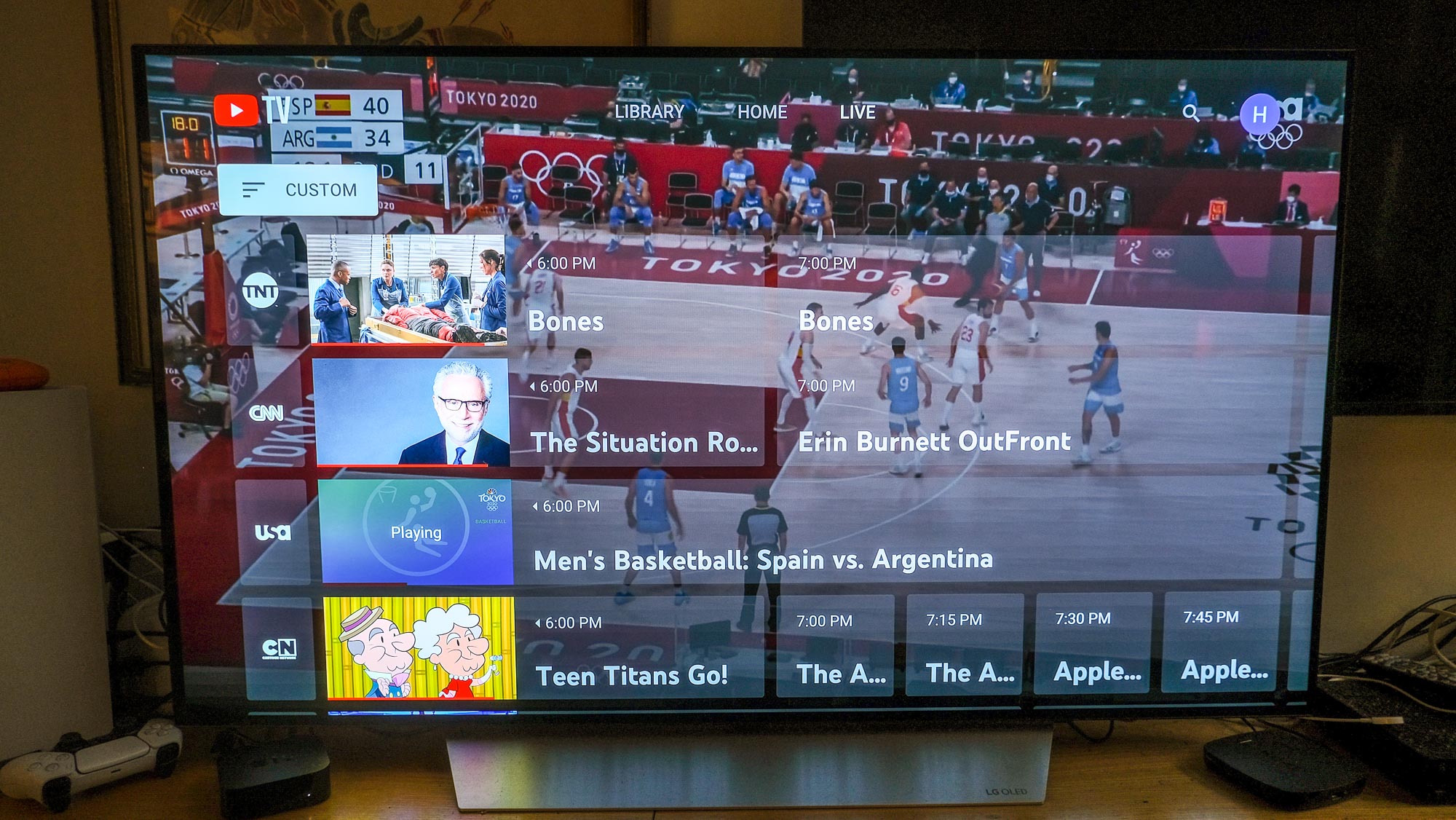 YouTube TV open to the channel grid overlaid over a basketball game