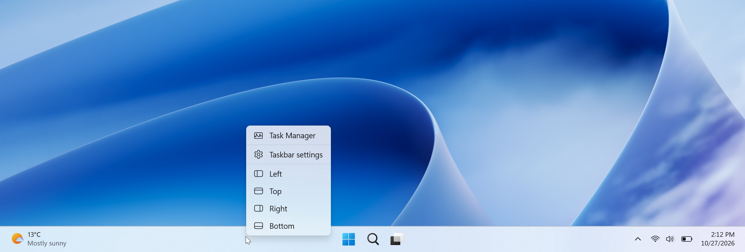 Windows 11 desktop showing a taskbar context menu with options to move the taskbar to the left, top, right, or bottom of the screen.
