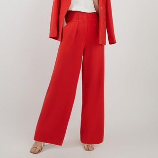 Cropped image of woman wearing red trousers