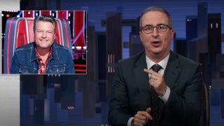 John Oliver laughing and pointing at Black Shelton on Last Week Tonight