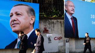 People in Istanbul, Turkey, on May 2, 2023, are passing by a photo of opposition Republican People's Party (CHP) leader Kemal Kilicdaroglu and Turkish President Recep Tayyip Erdogan as general elections are set to be held in Turkey on May 14, 2023 to elect the President of Turkey and to elect the parliamentary elections.