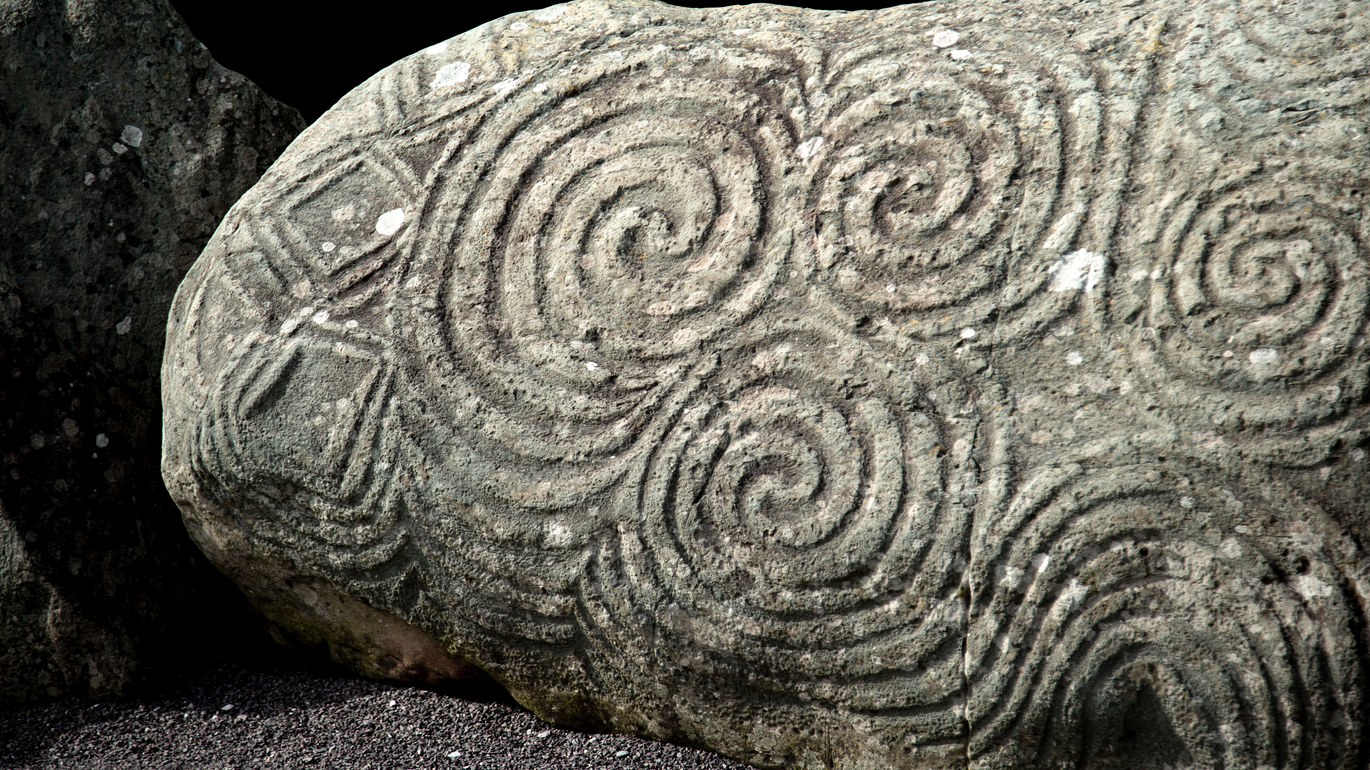 a cylindrical stone covered with overlapping circles from close up