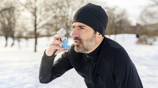 male runner with asthma inhaler