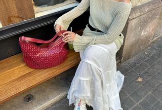 Woman wearing a white maxi skirt.