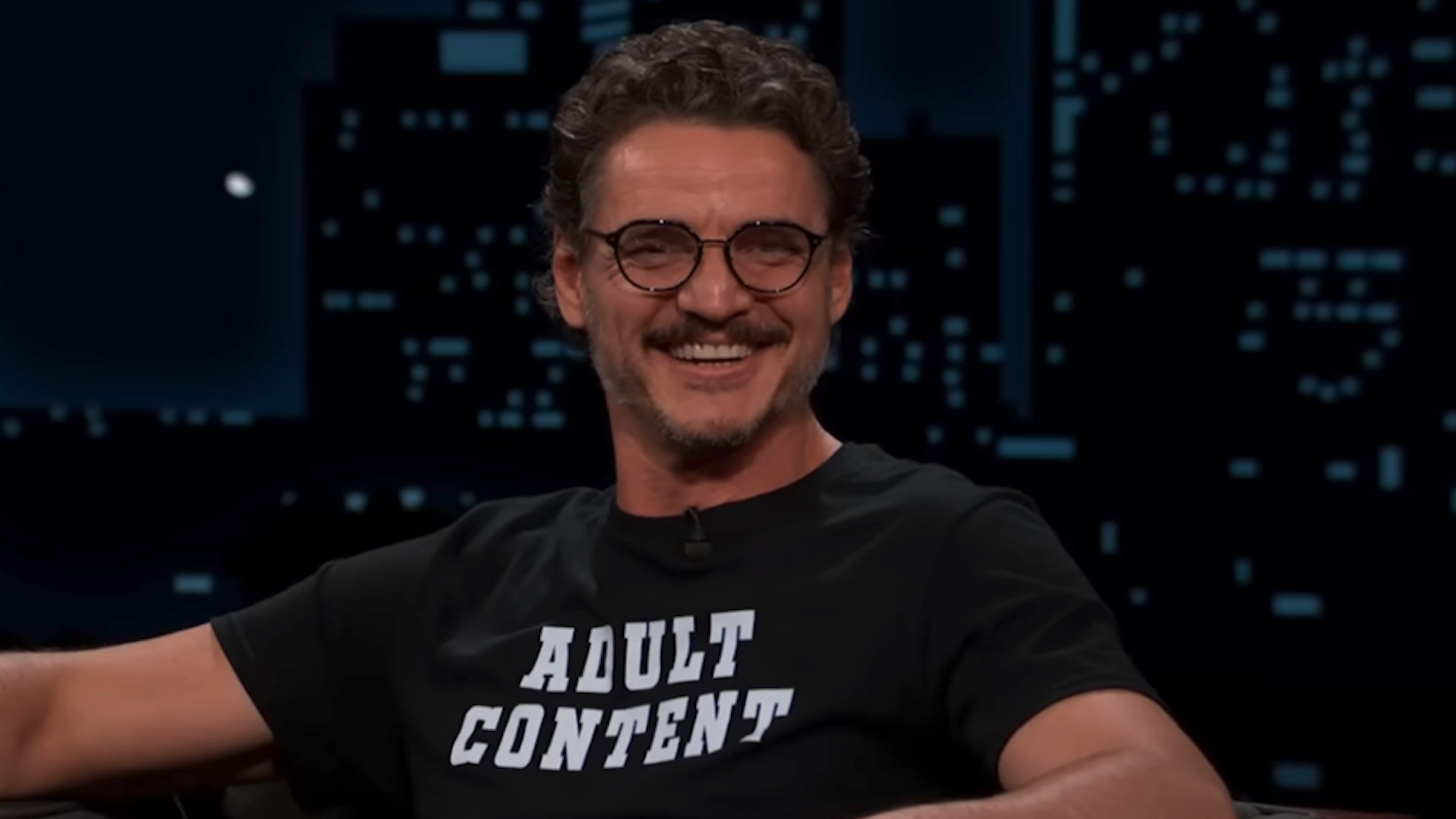 Pedro Pascal in a T-shirt that says "Adult Content" while on Jimmy Kimmel Live!