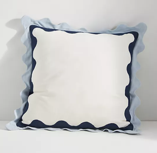Throw pillow with wavy edges.
