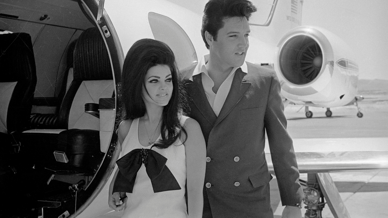 Elvis and Priscilla Presley Posing near Airplane