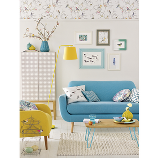living area with blue sofa and bird frame