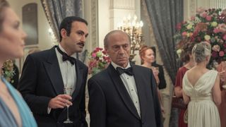 Dodi Fayed (Khalid Abdalla) and his father, Mohamed Al Fayed (Salim Daw) at a gathering in The Crown season 5.