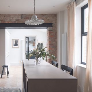 Kitchen with island and linen curtains against window