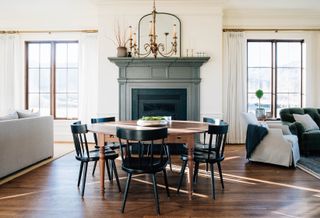 open plan dining living room with round table and black chairs