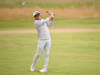 Rickie Fowler hitting an iron shot on the fairway