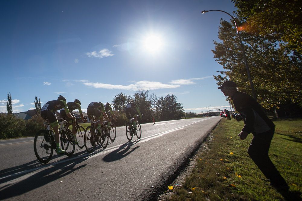 A fan cheers as another team heads towards the finish