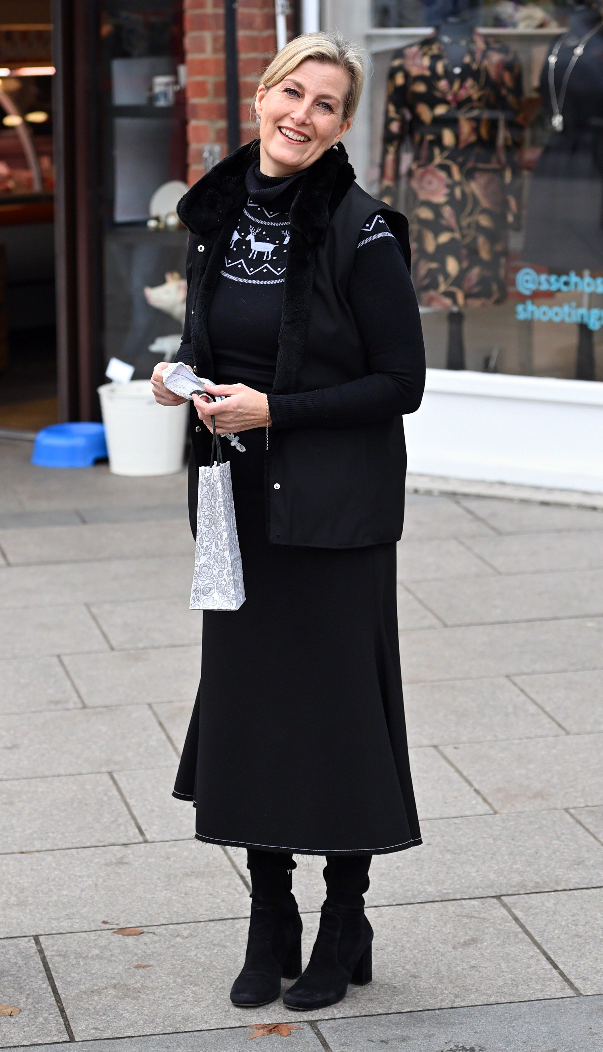 Duchess Sophie wearing black gilet, knitwear, midi skirt and knee high boots while visiting the Shooting Star Children&amp;rsquo;s Hospices Charity Shop on 09 December, 2024