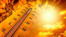 A thermometer showing a temperature of 100 degrees with a blazing sun in the background.