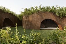 The Aranyani Pavilion seen in its green setting that highlights its natural materials and organic construction