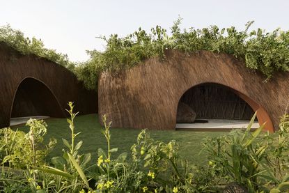 The Aranyani Pavilion seen in its green setting that highlights its natural materials and organic construction