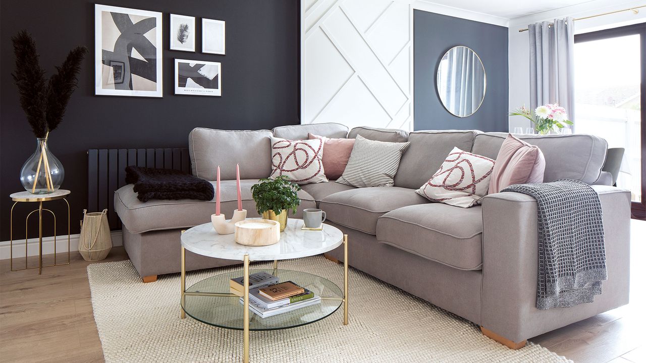 living room with black and white panelled walls and neutral corner sofa