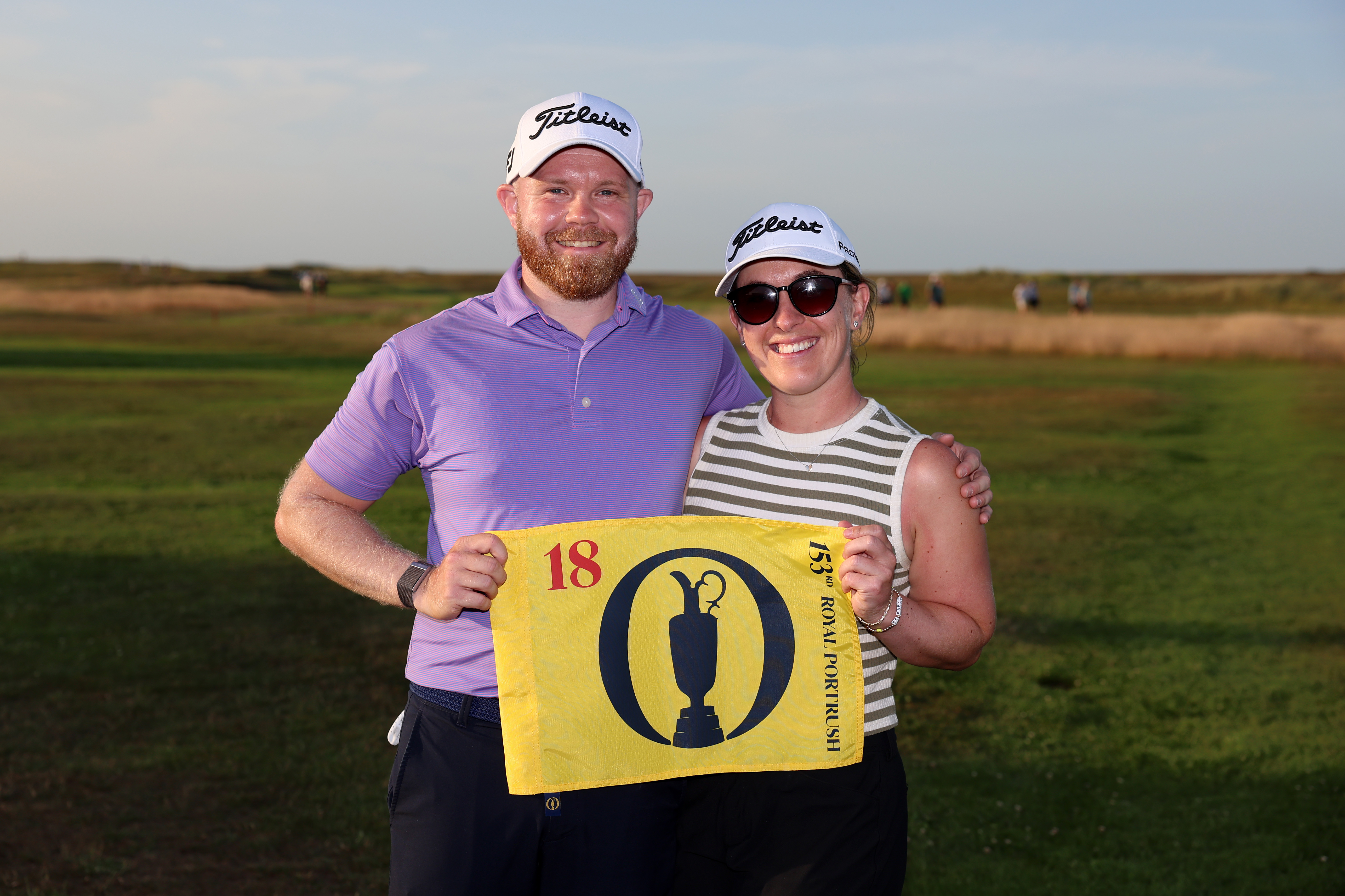 Nathan Kimsey and his partner hold an Open Championship flag