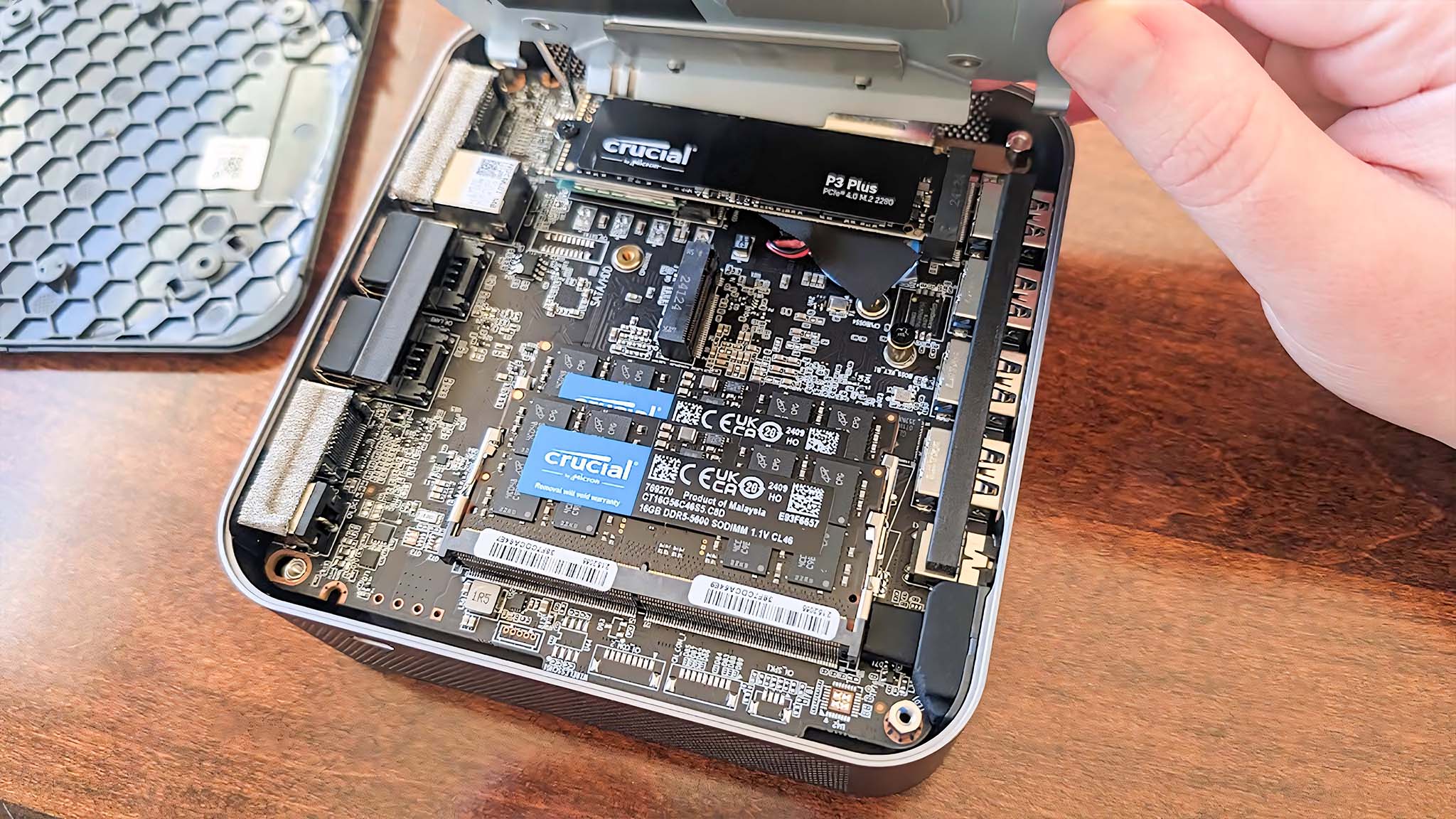 The interior of the Geekom GT1 Mega with RAM and SSD slots visible.