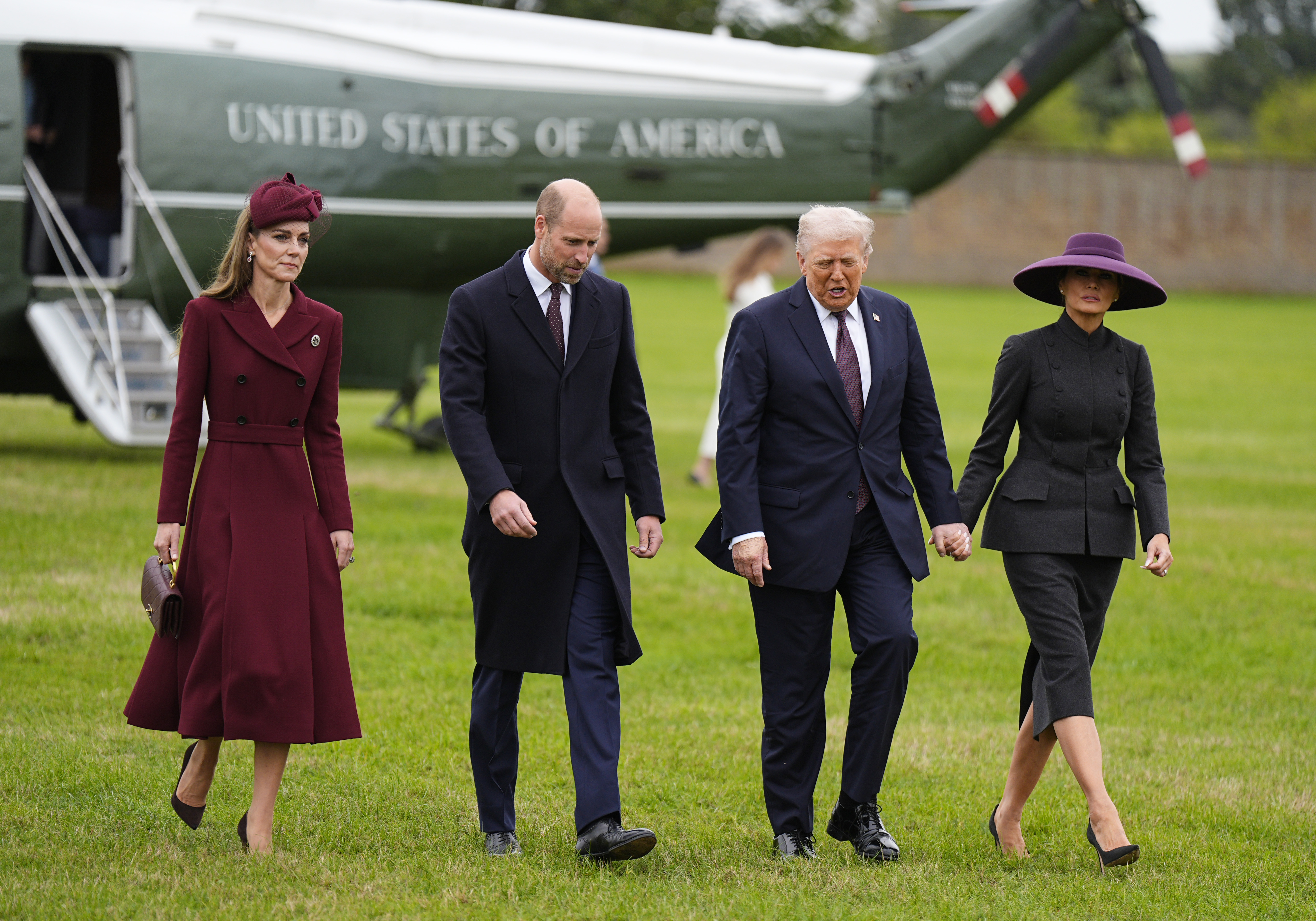 Kate MIddleton wears a wine coat dress and greets Melania Trump during the US state visit on September 17
