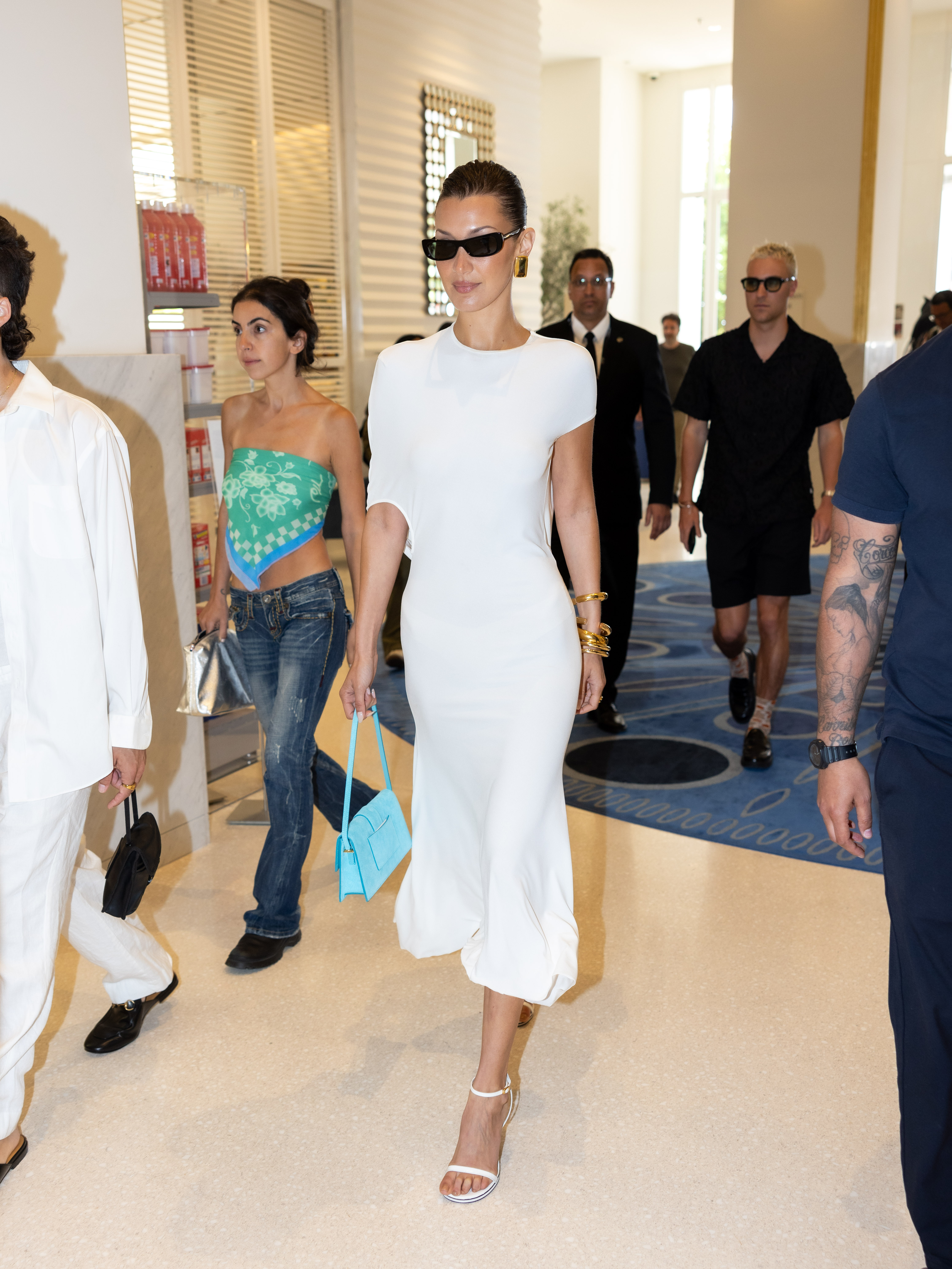 Bella Hadid styles a white dress with bangles.