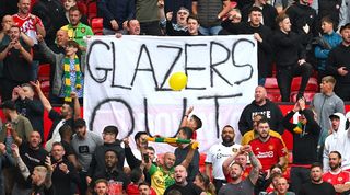 MAnchester United fans with a 'Glazers out' banner at Old Trafford in their Premier League game against Nottingham Forest in August 2023.