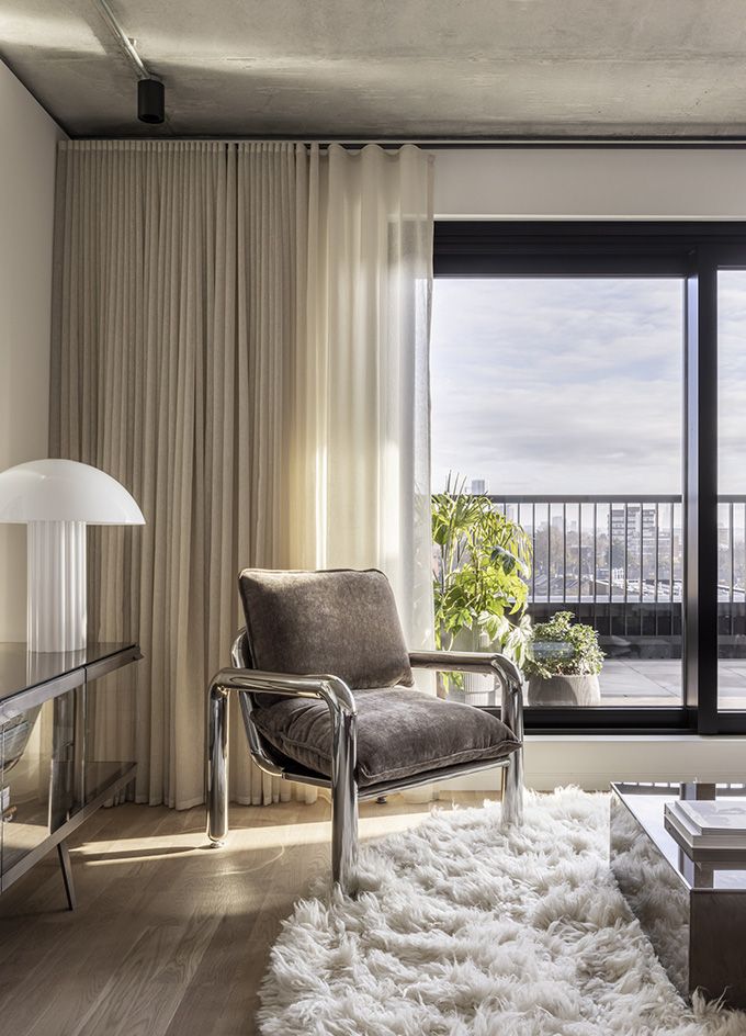 armchair and london views from terrace at Vabel Lawrence Penthouse