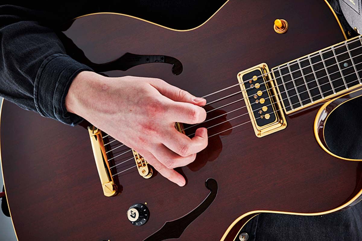 From this anchored position, Joe can easily pluck the highest strings with his second and third fingers, like for those open string snaps in Walk This Way.