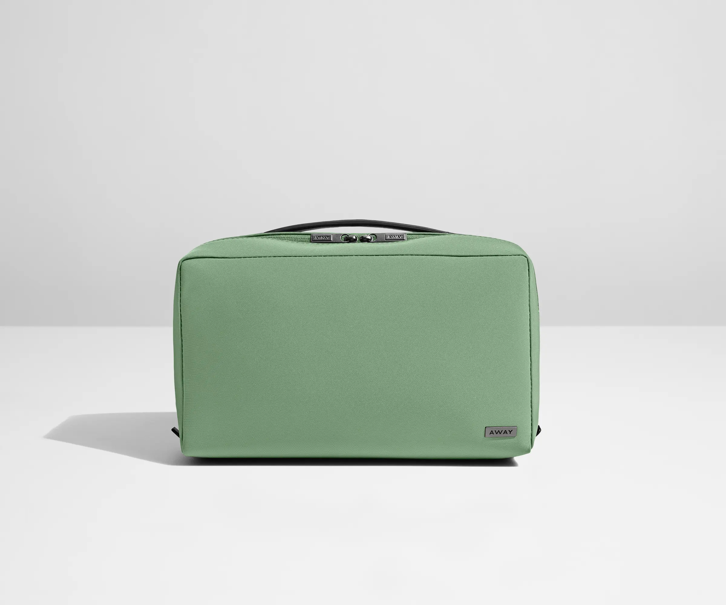 A sage green large Away toiletry bag