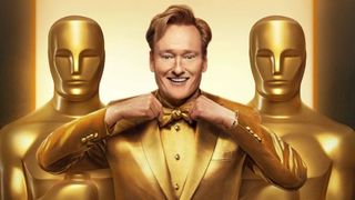 98th Academy Awards host Conan O'Brien wearing a gold tuxedo standing alongside two human-sized Oscar statuettes in a promotional image for the 2026 Oscars.