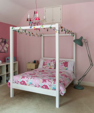 pink bedroom with bed and lamp stand