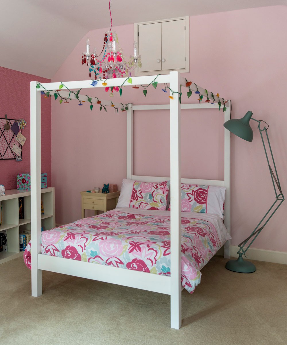 pink bedroom with bed and lamp stand
