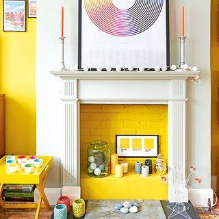 fireplace with yellow painted brick and candles