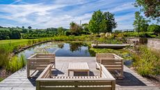 natural pools with wooden deck and seating by Poolscape