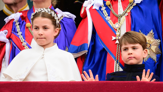 Britain's Princess Charlotte of Wales and Britain's Prince Louis of Wales stand on the Buckingham Palace balcony as they wait for the Royal Air Force fly-past in central London on May 6, 2023, after the coronations of King Charles III and Queen Camilla