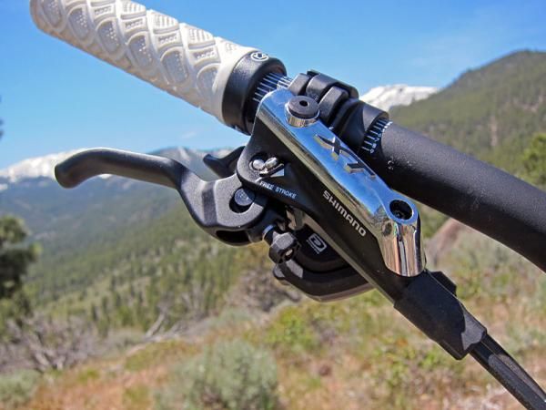The sleek new Shimano Deore XT brake levers are near carbon copies of the XTR Trail flagship with similar one-finger lever blades, Servo Wave variable leverage ratios, and a revamped pivot architecture that feels more natural in your hands.