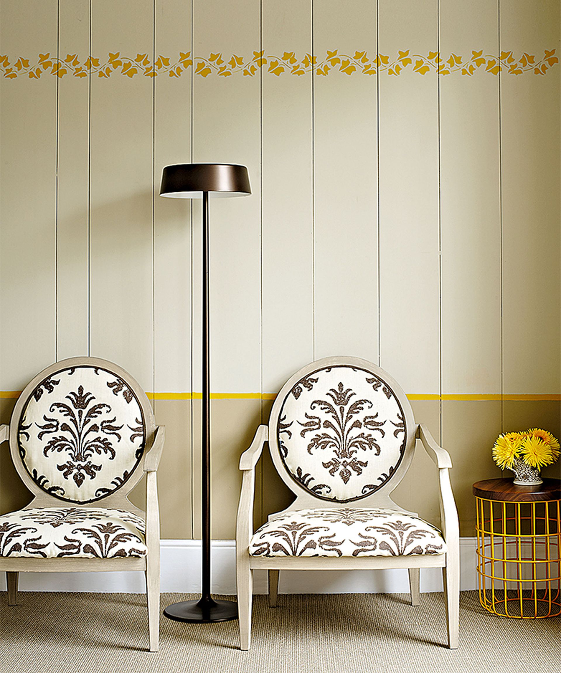 Panelling ideas for walls with yellow painted panelling and armchairs