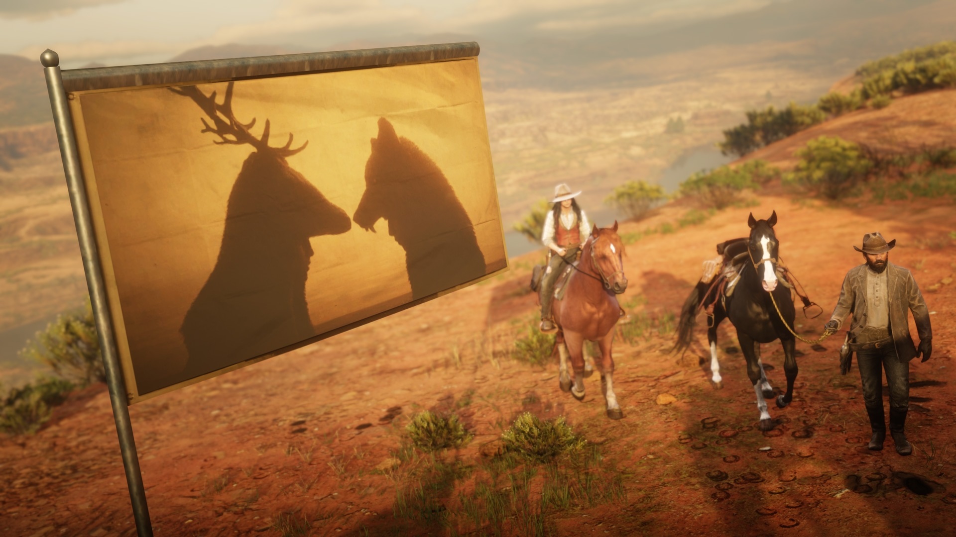 Red Dead Redemption Online - Two players ride beneath a camp flag which shows two players in elk and wolf hoods at sunset.