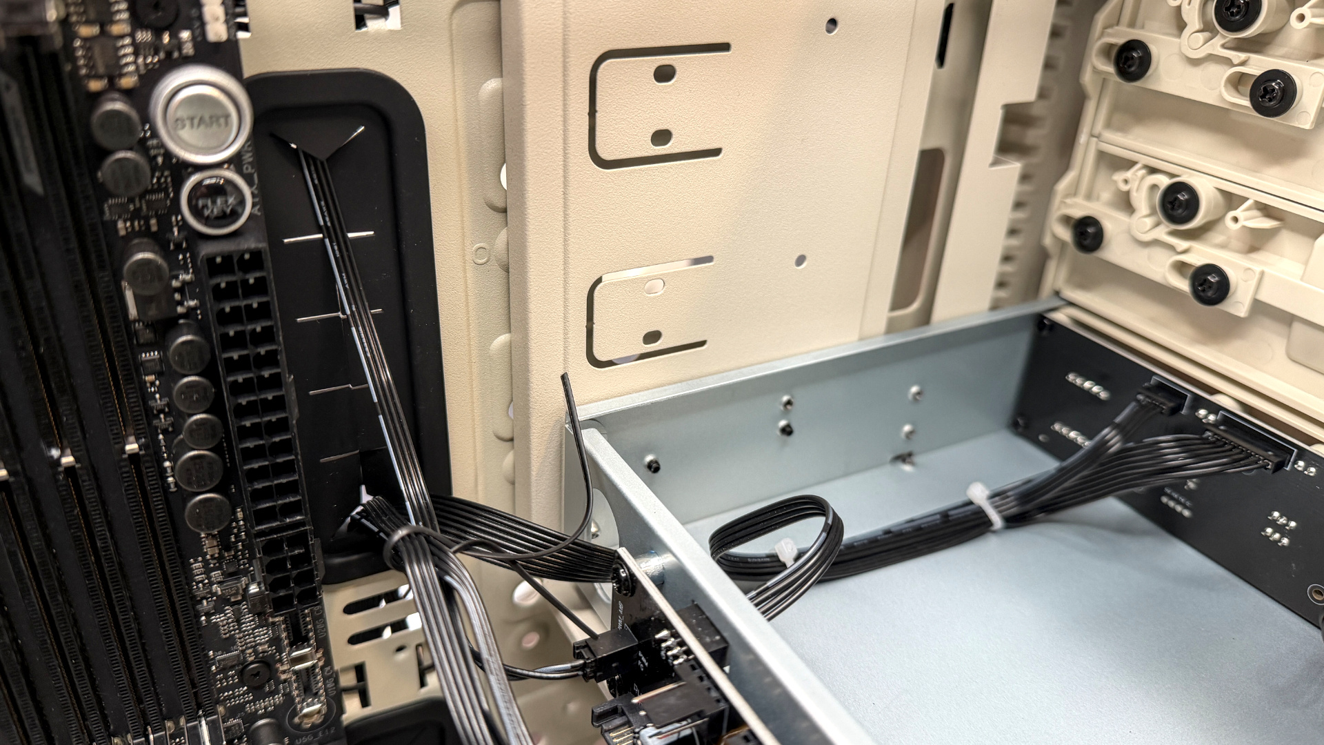 The retro-styled Silverstone FLP02 PC case as a PC is being built into it on a desk.