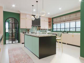 Kitchen with emerald green features and light wood cabinetry.